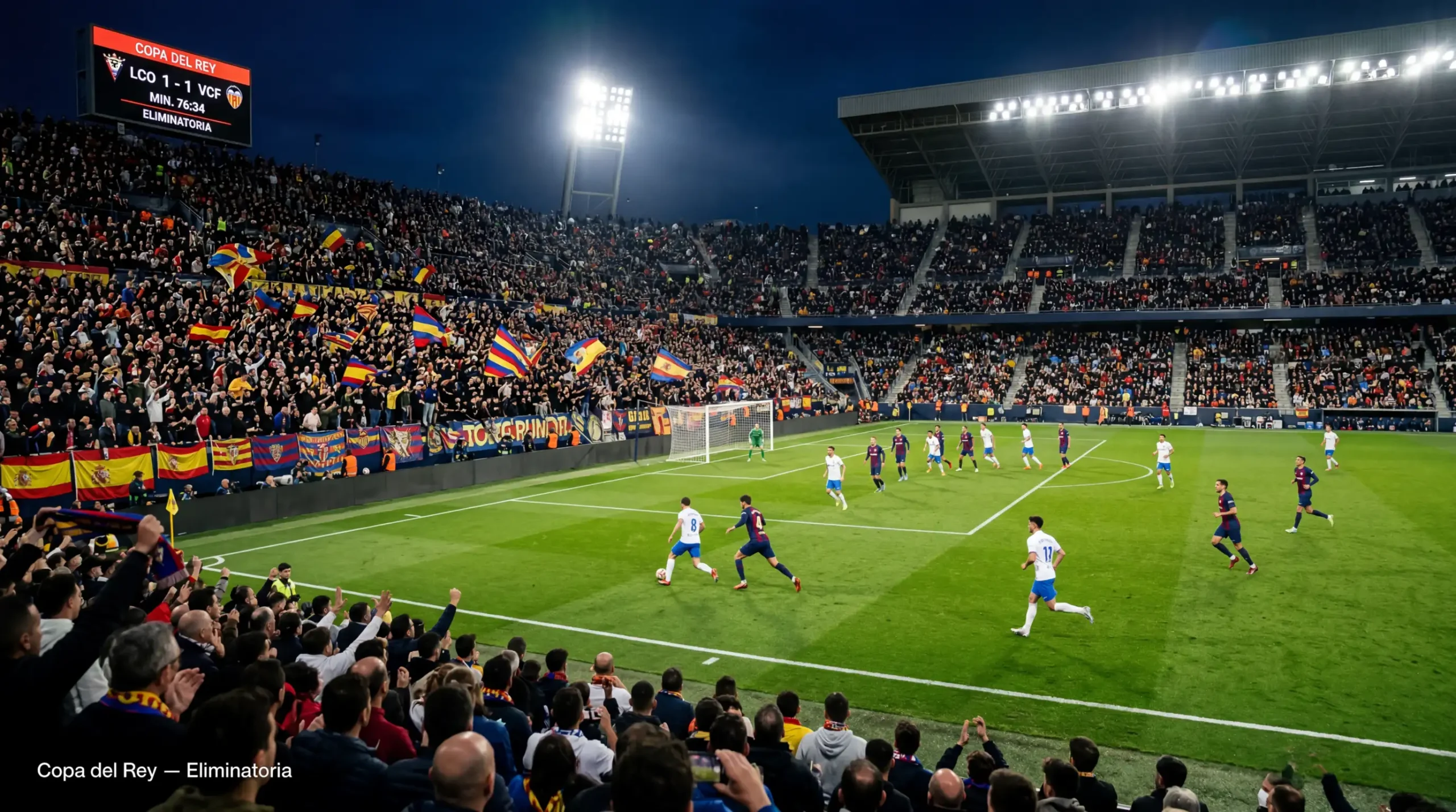 Estadio de fútbol durante un partido nocturno de Copa del Rey con afición animando