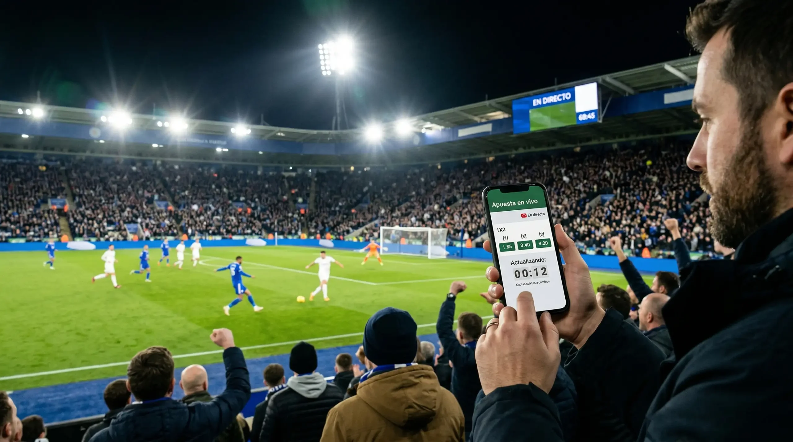 Aficionados en estadio de fútbol consultando cuotas de apuestas en directo en el móvil